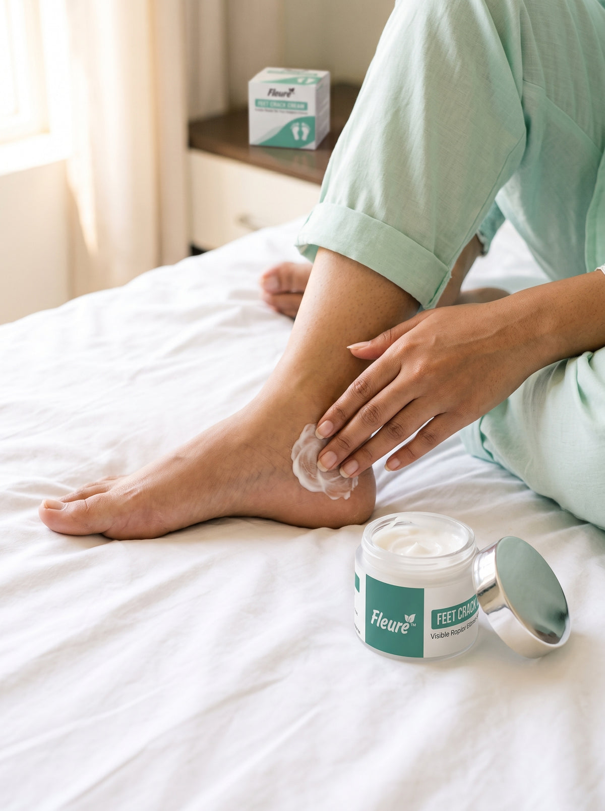 Woman applying Fleuré Feet Crack Cream on heel for daily foot care ritual
